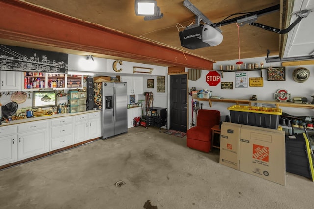 2542 Eckert Rd, Lexington, OH 44904 - garage with stainless steel fridge, a garage door opener, and a workshop area