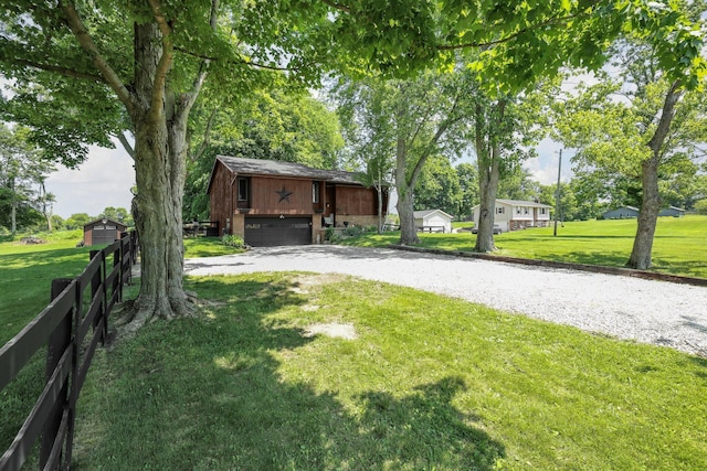 2542 Eckert Rd, Lexington, OH 44904 - view of yard featuring driveway, an attached garage, and an outbuilding
