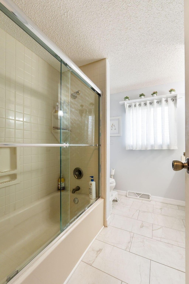 8621 Renford Ct, Powell, OH 43065 - full bath featuring bath / shower combo with glass door, a textured ceiling, and marble look tile flooring