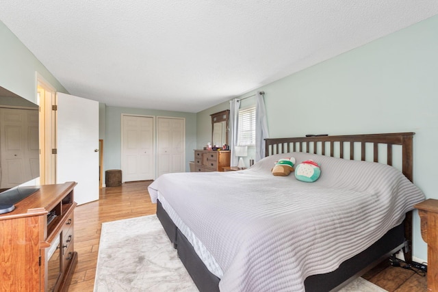 8621 Renford Ct, Powell, OH 43065 - bedroom with light wood finished floors and two closets