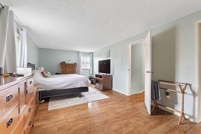 8621 Renford Ct, Powell, OH 43065 - bedroom featuring a textured ceiling and light wood-style flooring