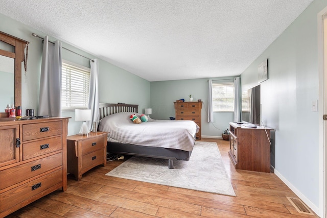8621 Renford Ct, Powell, OH 43065 - bedroom with light wood finished floors and a textured ceiling