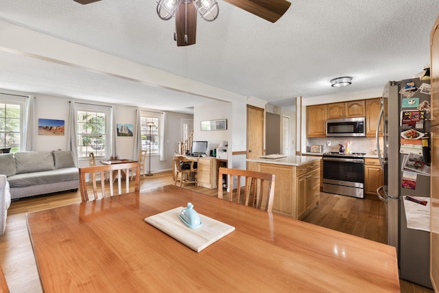 8621 Renford Ct, Powell, OH 43065 - dining room featuring a ceiling fan, wood finished floors, and a textured ceiling
