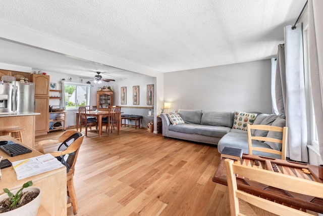 8621 Renford Ct, Powell, OH 43065 - living area featuring a textured ceiling, ceiling fan, and light wood-type flooring