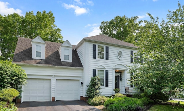 4949 Heath Gate Dr, New Albany, OH 43054 - colonial home with driveway, an attached garage, and a shingled roof