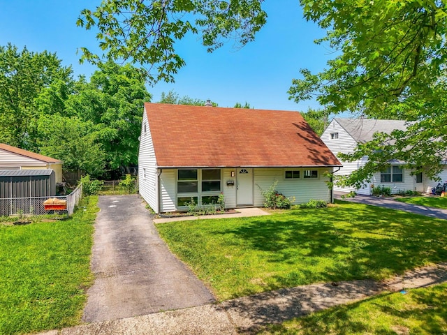 3920 Astor Ave, Columbus, OH 43227 - cape cod house featuring asphalt driveway and roof with shingles