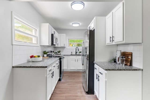 3920 Astor Ave, Columbus, OH 43227 - kitchen featuring stainless steel appliances, tasteful backsplash, and light wood-style floors