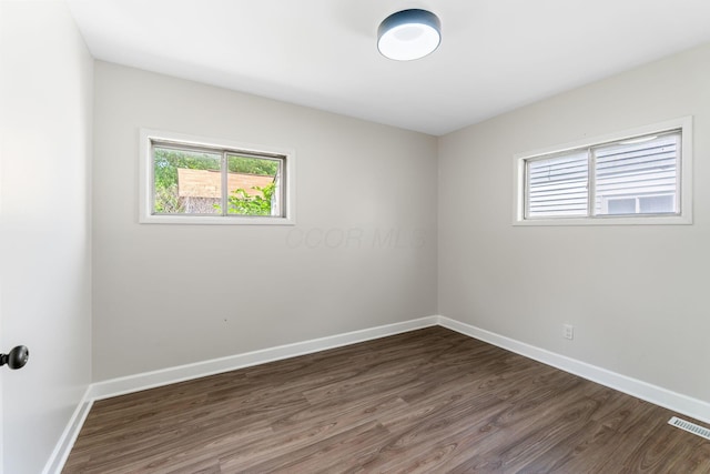 3920 Astor Ave, Columbus, OH 43227 - empty room featuring healthy amount of natural light and dark wood-style floors