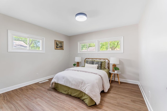 3920 Astor Ave, Columbus, OH 43227 - bedroom featuring multiple windows and light wood-type flooring