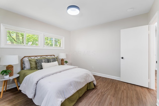 3920 Astor Ave, Columbus, OH 43227 - bedroom with wood finished floors and multiple windows