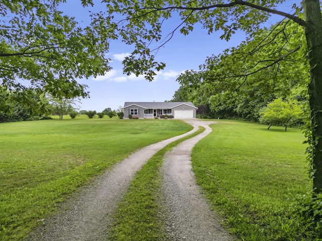 1290 Knorr Rd, Galion, OH 44833 - ranch-style house featuring dirt driveway, a front lawn, and an attached garage