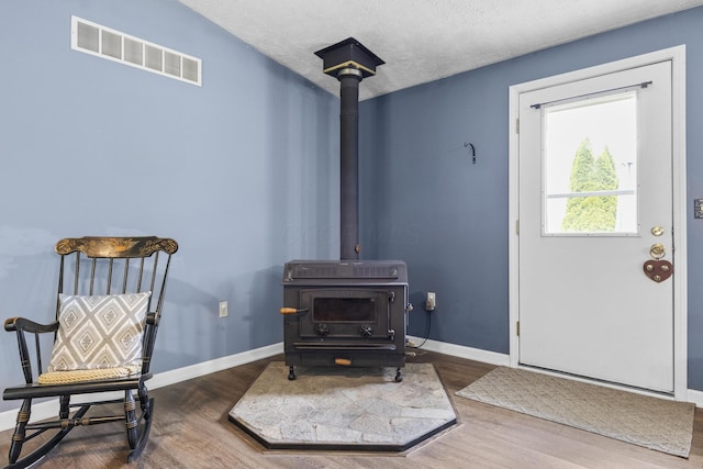 1290 Knorr Rd, Galion, OH 44833 - entrance foyer featuring wood finished floors and a wood stove