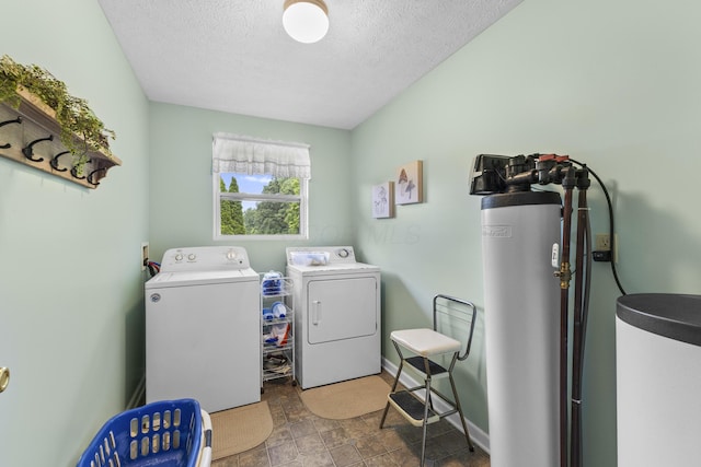 1290 Knorr Rd, Galion, OH 44833 - laundry area with washing machine and clothes dryer, a textured ceiling, water heater, and stone finish floors