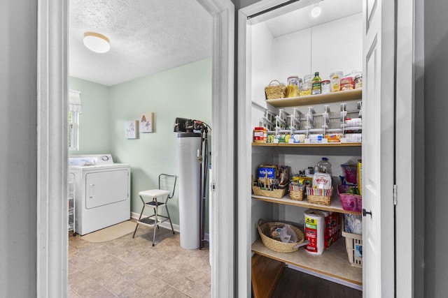1290 Knorr Rd, Galion, OH 44833 - laundry room with washer / dryer, gas water heater, and a textured ceiling