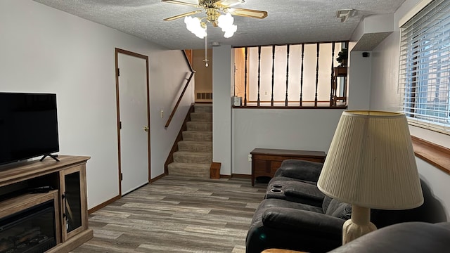 5109 Magnolia Blossom Blvd, Columbus, OH 43230 - living room with ceiling fan, a textured ceiling, wood finished floors, and stairs