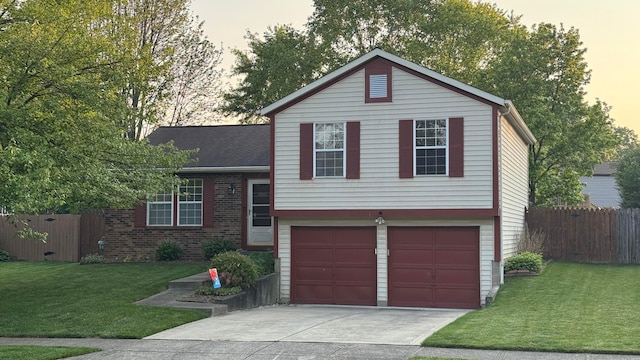 5109 Magnolia Blossom Blvd, Columbus, OH 43230 - tri-level home featuring concrete driveway, an attached garage, and brick siding