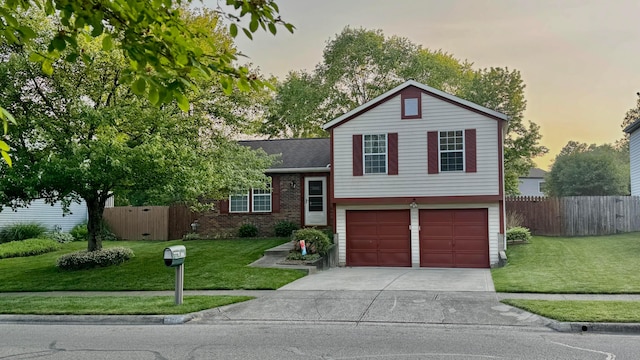 5109 Magnolia Blossom Blvd, Columbus, OH 43230 - tri-level home featuring concrete driveway, a garage, brick siding, and a shingled roof