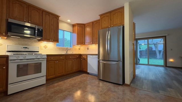 5109 Magnolia Blossom Blvd, Columbus, OH 43230 - kitchen featuring stainless steel appliances, decorative backsplash, brown cabinets, recessed lighting, and light countertops
