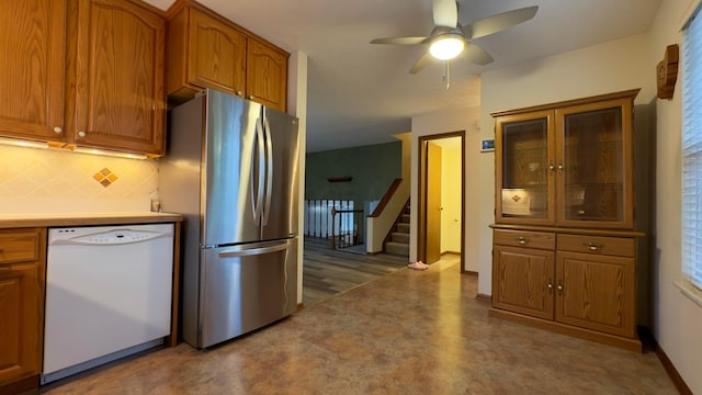 5109 Magnolia Blossom Blvd, Columbus, OH 43230 - kitchen featuring freestanding refrigerator, white dishwasher, backsplash, brown cabinetry, and a ceiling fan