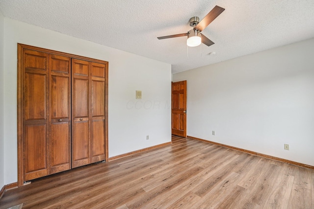 7591 Creekbend Dr, Pickerington, OH 43147 - unfurnished bedroom with light wood finished floors, a closet, a textured ceiling, and ceiling fan