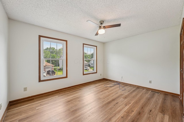 7591 Creekbend Dr, Pickerington, OH 43147 - empty room with light wood-type flooring, a textured ceiling, and a ceiling fan