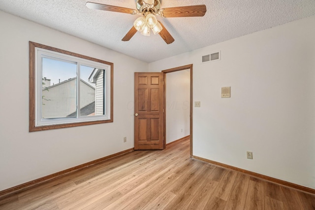 7591 Creekbend Dr, Pickerington, OH 43147 - unfurnished room featuring a textured ceiling, light wood finished floors, and ceiling fan