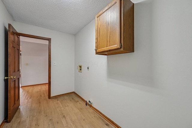 7591 Creekbend Dr, Pickerington, OH 43147 - laundry room featuring cabinet space, light wood-type flooring, washer hookup, hookup for an electric dryer, and a textured ceiling