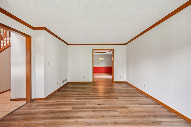 7591 Creekbend Dr, Pickerington, OH 43147 - unfurnished room with wood finished floors, a textured ceiling, and ornamental molding
