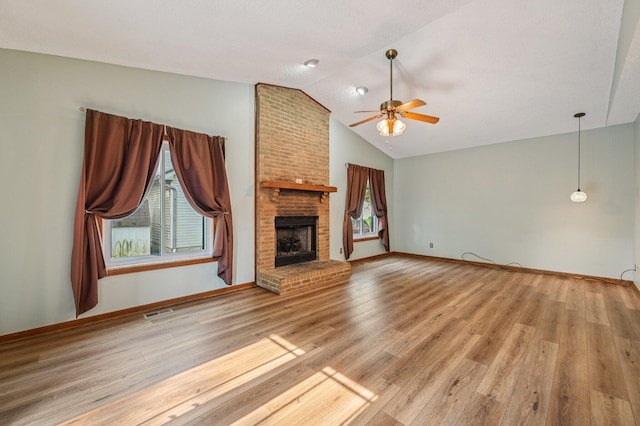7591 Creekbend Dr, Pickerington, OH 43147 - unfurnished living room with vaulted ceiling, a ceiling fan, plenty of natural light, a fireplace, and wood finished floors
