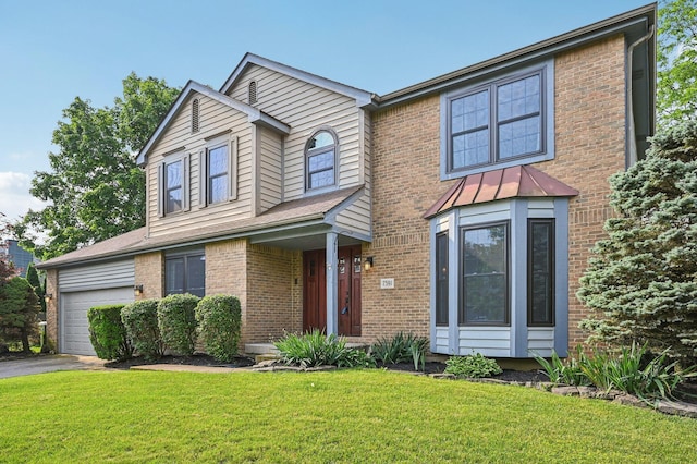 7591 Creekbend Dr, Pickerington, OH 43147 - traditional-style house with brick siding, a front yard, driveway, and an attached garage