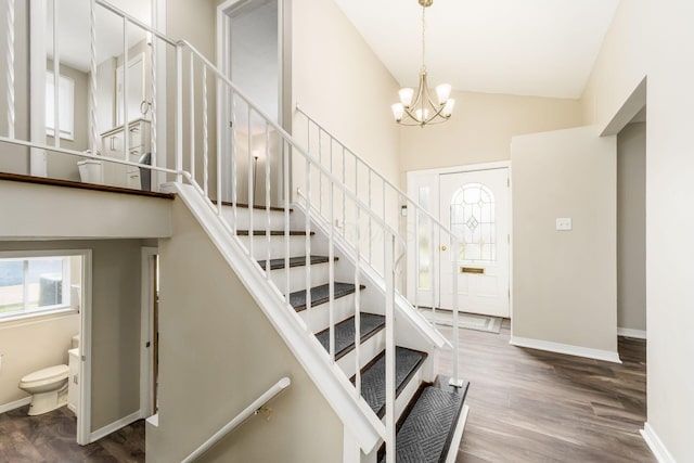 5032 Labelle Dr, Columbus, OH 43232 - stairs featuring plenty of natural light, high vaulted ceiling, wood finished floors, and a chandelier