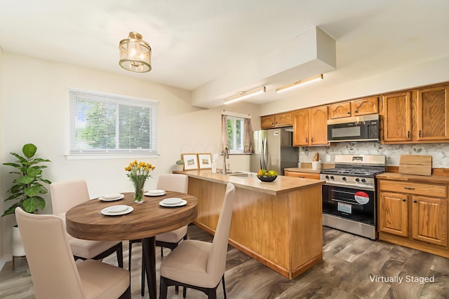5032 Labelle Dr, Columbus, OH 43232 - kitchen featuring appliances with stainless steel finishes, dark wood-style flooring, backsplash, brown cabinets, and light countertops