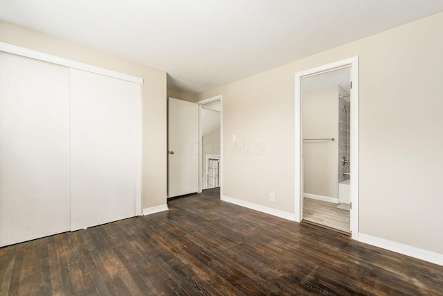 5032 Labelle Dr, Columbus, OH 43232 - unfurnished bedroom with dark wood-type flooring, a closet, and ensuite bath