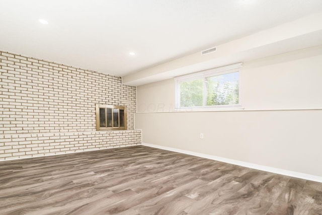 5032 Labelle Dr, Columbus, OH 43232 - below grade area with a fireplace, brick wall, wood finished floors, and recessed lighting