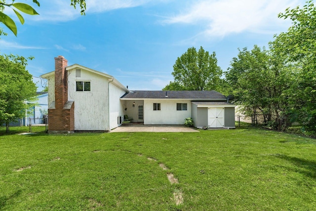5032 Labelle Dr, Columbus, OH 43232 - back of house with a patio, a storage unit, stucco siding, and a chimney