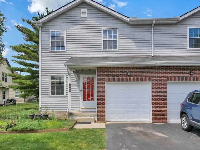4809 King Albert Dr Unit 1A, Hilliard, OH 43026 - view of front of home with a garage, brick siding, and driveway