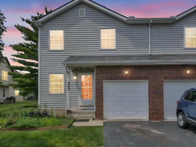 4809 King Albert Dr Unit 1A, Hilliard, OH 43026 - traditional home featuring an attached garage, brick siding, and driveway