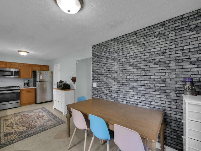 4809 King Albert Dr Unit 1A, Hilliard, OH 43026 - dining space featuring light tile patterned floors and a textured ceiling