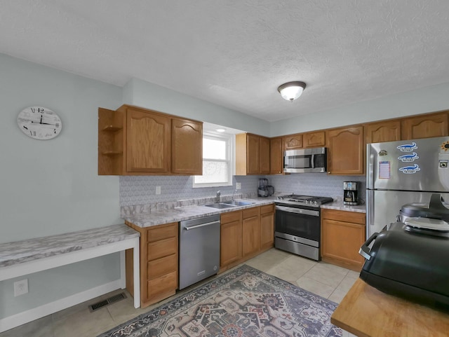 4809 King Albert Dr Unit 1A, Hilliard, OH 43026 - kitchen with appliances with stainless steel finishes, backsplash, open shelves, light tile patterned floors, and light countertops
