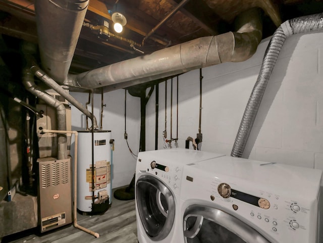4809 King Albert Dr Unit 1A, Hilliard, OH 43026 - laundry room with gas water heater, washer and clothes dryer, wood finished floors, and concrete block wall