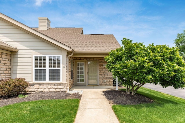8209 Farm Crossing Cir, Powell, OH 43065 - doorway to property with stone siding, roof with shingles, a chimney, and a lawn