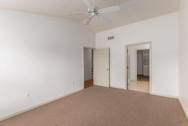 8209 Farm Crossing Cir, Powell, OH 43065 - unfurnished bedroom with carpet, a spacious closet, high vaulted ceiling, ceiling fan, and a closet
