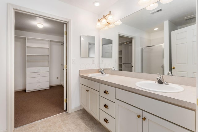 8209 Farm Crossing Cir, Powell, OH 43065 - full bathroom with a spacious closet, double vanity, a shower stall, and tile patterned flooring