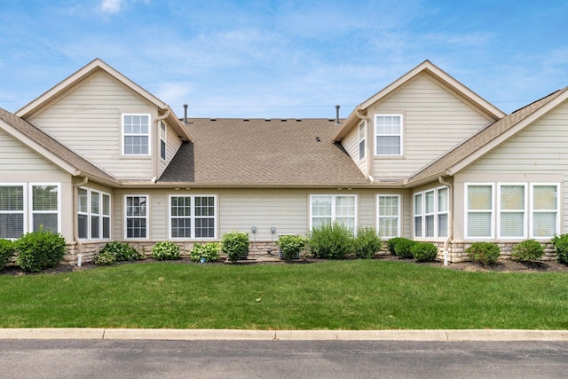 8209 Farm Crossing Cir, Powell, OH 43065 - back of property featuring a shingled roof, a yard, and stone siding