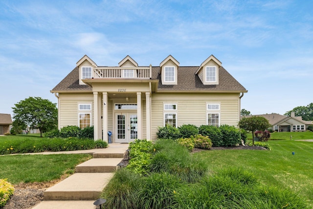 8209 Farm Crossing Cir, Powell, OH 43065 - view of front of house featuring french doors, a balcony, a front lawn, and a shingled roof