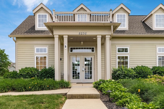 8209 Farm Crossing Cir, Powell, OH 43065 - entrance to property with french doors, a shingled roof, and a balcony