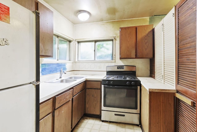 934-936 Kramer Ave, Columbus, OH 43212 - kitchen featuring freestanding refrigerator, gas stove, light countertops, and brown cabinets