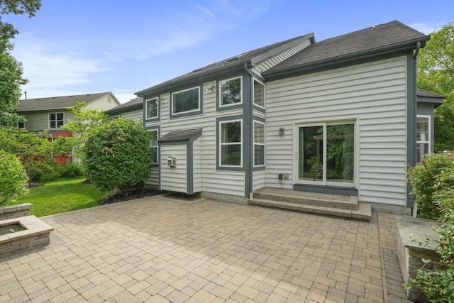 8020 Glenmore Dr, Powell, OH 43065 - back of house featuring a patio area, a fire pit, and roof with shingles