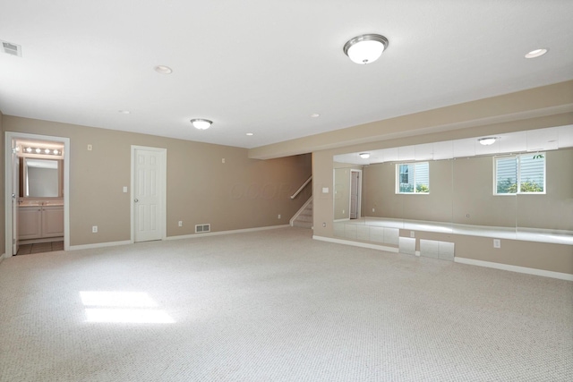 8020 Glenmore Dr, Powell, OH 43065 - basement featuring light carpet, stairway, and recessed lighting