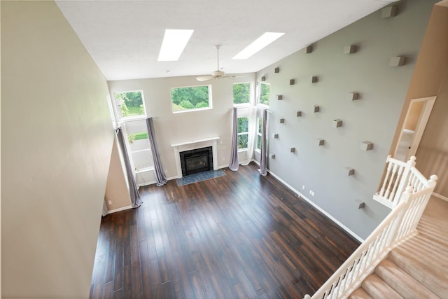 8020 Glenmore Dr, Powell, OH 43065 - unfurnished living room with a skylight, a premium fireplace, stairway, dark wood finished floors, and lofted ceiling